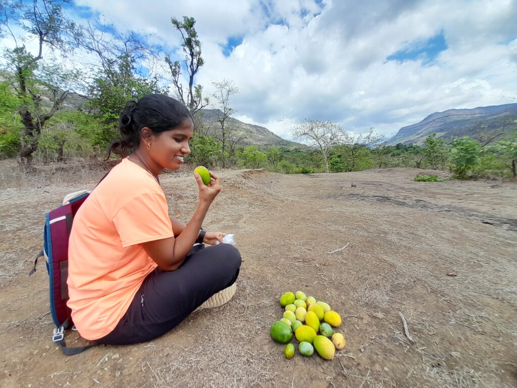 Enjoying wild mango during hike to Kondana caves